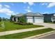 Charming single-story home with a well-manicured lawn, complemented by fresh landscaping, and a convenient two-car garage at 4407 Big Woods Way, Parrish, FL 34219