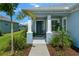Inviting front porch with classic columns, lush landscaping, and an elegant front door at 4407 Big Woods Way, Parrish, FL 34219