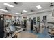Bright gym with a variety of exercise machines, mirrored walls, and ceiling fans for a comprehensive fitness experience at 4407 Big Woods Way, Parrish, FL 34219