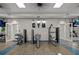 Well-equipped gym with modern exercise equipment, a brick accent wall, and bright lighting for a complete workout experience at 4407 Big Woods Way, Parrish, FL 34219