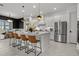 Bright, all-white kitchen with stainless steel appliances, large island, and stylish pendant lighting at 4407 Big Woods Way, Parrish, FL 34219