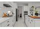Well-lit kitchen with stainless steel appliances and white cabinetry at 4407 Big Woods Way, Parrish, FL 34219