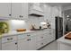 Kitchen featuring white cabinets, stainless steel appliances, and plenty of counter space at 4407 Big Woods Way, Parrish, FL 34219