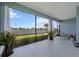 Lanai featuring stylish decor and serene views of the lake and landscaped backyard at 4407 Big Woods Way, Parrish, FL 34219