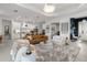 Open-concept living room with kitchen, modern decor, and lots of natural light at 4407 Big Woods Way, Parrish, FL 34219
