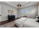 Inviting main bedroom featuring hardwood floors, a woven ceiling fan, and natural light at 4407 Big Woods Way, Parrish, FL 34219