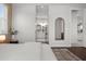 A bright, spacious main bedroom leads into en suite bathroom with a unique mirror at 4407 Big Woods Way, Parrish, FL 34219