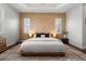 Comfortable main bedroom featuring tray ceilings, a stylish accent wall, and a cozy rug at 4407 Big Woods Way, Parrish, FL 34219