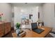 View through French doors to an open concept living space from a home office, with desk, decor, and hardwood floors at 4407 Big Woods Way, Parrish, FL 34219