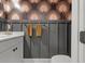 Stylish powder room featuring decorative wallpaper, paneled accent wall, and modern fixtures at 4407 Big Woods Way, Parrish, FL 34219