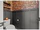 Stylish powder room featuring decorative wallpaper, paneled accent wall, floating shelves and modern fixtures at 4407 Big Woods Way, Parrish, FL 34219