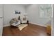 Light-filled room with hardwood floors, featuring two chairs, accent pillows, and a stylish rug at 4407 Big Woods Way, Parrish, FL 34219