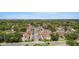 An aerial view showcasing a well-maintained condo community nestled among lush greenery at 4475 Sandner Dr, Sarasota, FL 34243