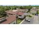 A high-angle view of the condo complex surrounded by trees, and parking area at 4475 Sandner Dr, Sarasota, FL 34243