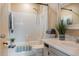 Bathroom with white tile, shower curtain, and a single sink vanity at 4475 Sandner Dr, Sarasota, FL 34243