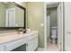 Bathroom featuring a vanity with an undermount sink and a shower behind a door at 4475 Sandner Dr, Sarasota, FL 34243