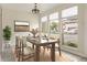 Bright dining room with large windows, a modern light fixture, and a view of the outdoors at 4475 Sandner Dr, Sarasota, FL 34243