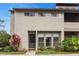Front exterior of a two-story condo featuring well-manicured landscaping and inviting curb appeal at 4475 Sandner Dr, Sarasota, FL 34243
