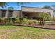 Well-kept condo exterior featuring manicured landscaping and covered parking at 4475 Sandner Dr, Sarasota, FL 34243