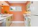 Bright kitchen features tile flooring, stainless steel sink, and white appliances at 4475 Sandner Dr, Sarasota, FL 34243