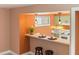 Cozy kitchen bar area with pendant lighting, offering a perfect spot for casual dining and socializing at 4475 Sandner Dr, Sarasota, FL 34243