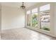 Bright, sun-filled living room features tile flooring and a wall of windows, creating a welcoming atmosphere at 4475 Sandner Dr, Sarasota, FL 34243