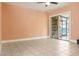 Spacious living room with tile flooring and sliding glass doors at 4475 Sandner Dr, Sarasota, FL 34243