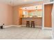 Open concept living area with tile flooring looking into the kitchen at 4475 Sandner Dr, Sarasota, FL 34243