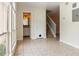 Bright entryway with views of a bathroom, a staircase, and tile flooring leading to other parts of the home at 4475 Sandner Dr, Sarasota, FL 34243