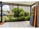 View of the screened-in patio overlooking lush landscaping at 4475 Sandner Dr, Sarasota, FL 34243