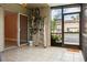 Tiled, screened-in patio with access to the outside and interior, also storing bikes and a ladder at 4475 Sandner Dr, Sarasota, FL 34243