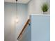 Stairway featuring modern lighting and a wooden handrail at 4475 Sandner Dr, Sarasota, FL 34243