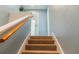 Carpeted stairway with wooden handrail leading to the next floor of this home at 4475 Sandner Dr, Sarasota, FL 34243