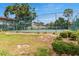 Community tennis court in Hidden Hollow, a Townhome Condominium with shade trees at 4475 Sandner Dr, Sarasota, FL 34243