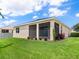 Landscaped backyard with screened patio and manicured lawn at 4615 73Rd E St, Bradenton, FL 34203