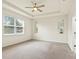 This primary bedroom features neutral walls, carpet flooring, a window, and tray ceiling with ceiling fan at 4615 73Rd E St, Bradenton, FL 34203
