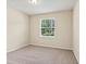 Bright bedroom showcasing neutral walls, carpet flooring, and a window with blinds at 4615 73Rd E St, Bradenton, FL 34203
