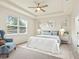 Bright, neutral bedroom with large window, tray ceiling, ceiling fan, and en-suite bathroom at 4615 73Rd E St, Bradenton, FL 34203