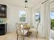Bright dining area featuring a glass table, upholstered chairs, and natural light from two windows at 4615 73Rd E St, Bradenton, FL 34203