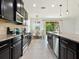 Bright, modern kitchen with black cabinets, granite countertops, stainless steel appliances, and eat-in nook at 4615 73Rd E St, Bradenton, FL 34203