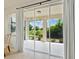 A view of the lanai through the sliding glass doors reveals an outdoor entertaining space with a view of the trees at 4615 73Rd E St, Bradenton, FL 34203