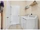 Functional laundry room with washer, dryer, storage shelves, and tiled floor at 4615 73Rd E St, Bradenton, FL 34203