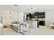 Open concept living space with modern kitchen, eat-in nook, neutral decor, and tile flooring at 4615 73Rd E St, Bradenton, FL 34203