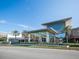Exterior view of a contemporary mall entrance featuring modern architectural design and palm trees at 4615 73Rd E St, Bradenton, FL 34203