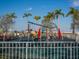 The community playground features a variety of play structures for children, surrounded by palm trees at 4615 73Rd E St, Bradenton, FL 34203