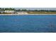Picturesque waterfront view with buoys in the water and picnic tables along the sandy shore at 4615 73Rd E St, Bradenton, FL 34203