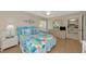 Well-lit bedroom featuring coastal decor, a dresser, and access to the kitchen at 4650 Ringwood Meadow # 37, Sarasota, FL 34235