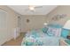 Cozy bedroom with coastal decor, ceiling fan, and a window offering a pleasant view at 4650 Ringwood Meadow # 37, Sarasota, FL 34235