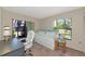 Bright bedroom featuring a daybed, desk, and view of the outdoors at 4650 Ringwood Meadow # 37, Sarasota, FL 34235