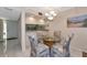 Bright and inviting dining area featuring a glass top table and stylish upholstered chairs at 4650 Ringwood Meadow # 37, Sarasota, FL 34235